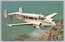 Transportation~Beechcraft Super H-17 In Air Over City~Vintage Postcard picture
