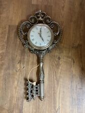 united antique brass wall clock shaped as a key picture