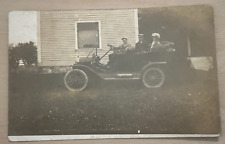 Vintage 1912 RPPC Postcard featuring Ford Model T Car in Front of a House picture