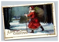 Vintage 1924 Christmas Postcard Santa with Presents Walking in Snowy Village picture