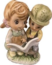Vintage Artmark figurine girl reading to a little boy picture