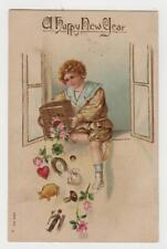 A Happy New Year. Embossed Post Card. Fancy Dressed Child / Horseshoe / Clover picture