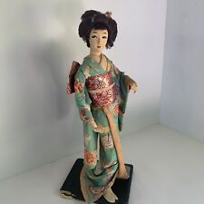 VINTAGE 15” GEISHA DOLL IN KIMONO W/ LARGE BOW.  MOUNTED ON BLACK STAND picture