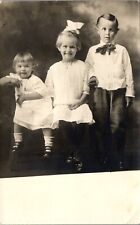 Vintage RPPC Postcard Three Smiling Children Early 1900s Studio Boy Cross Eyed  picture