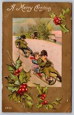 1910 MERRY CHRISTMAS Embossed Postcard Children sledding in Snow picture