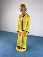 VINTAGE FIGURINE YELLOW BOWING ORIENTAL MAN picture