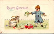 Easter Postcard Little Boy Feeding Bunny Rabbit Flowers Colored Eggs~138690 picture
