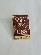 CBS Nagano 1998 Winter Olympic Games Souvenir Pin Maroon And Gold Colored picture