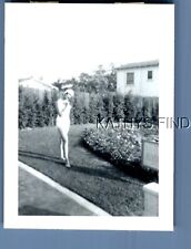 FOUND B&W PHOTO U_8491 PRETTY WOMAN IN SWIMSUIT POSED IN YARD picture