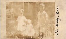 1910s Real Photo RPPC Postcard Kids in Backyard Brother Sisters Big Bow Siblings picture