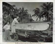 1947 Press Photo Gar Wood Sr. looks over speedboat gift from son Gar Jr., Miami picture