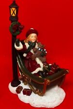 Mervyn's Village Square Christmas Girl in Sleigh Waiving Presents Figurine RARE picture