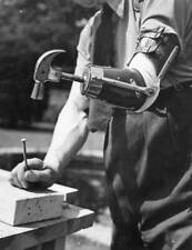 Captain Maxwell uses his artificial arm to hammer in a nail. - 1942 Old Photo 1 picture