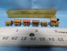 smallest train ever  tiny Brass Wheels 6 pieces ornament dollhouse buff picture