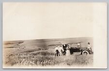 RPPC Group of People Posing in Front of Car in Cattle Field c1920 Real Photo Pos picture
