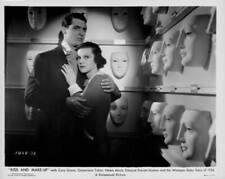 Cary Grant and Helen Mack in a room full of ceramic masks, in a - 1934 Old Photo picture
