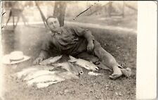 RPPC Barefoot Man Posing on Lawn with His Catch of Fish c1920s Postcard W4 picture