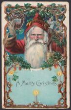 Santa Claus Christmas postcard 1909 holds heart-shape, smokes pipe amid branches picture