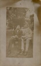 c1910s RPPC of Two Men in Suits with Hats in Laps Outside Real Photo Postcard picture