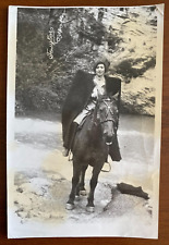 Beautiful girl riding a horse. Vintage photo picture