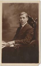 RPPC Young Man in Studio Sitting in Ornate Chair c1910 Real Photo Postcard picture