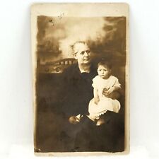 Vintage RPPC Woman In Black Holding Baby Girl In White Dress Real Photo Postcard picture