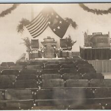 c1910s Unknown Event Room RPPC US Flag Seats Flowers Speaker Stage Ceremony A203 picture