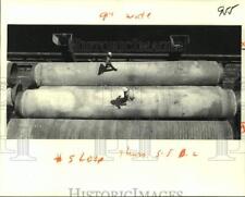 1979 Press Photo Two workman are dwarfed by the 40-foot, 32-ton section of pipe picture