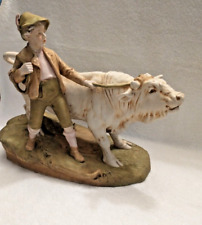 A Large Antique Royal Dux Porcelain Figurine of a Boy Walking Beside a Bull picture