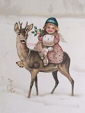 A Happy Christmas Girl with Muff Riding a Deer Angel Bells Holly Postcard c1910s picture