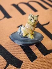 Hand Carved Stone Cat Perched On River Rock picture