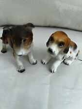 Two Dog Figurines Both Are Numbered picture