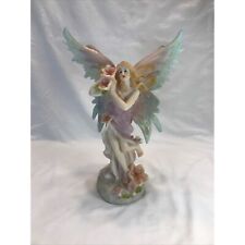 Beautiful pastel multicolored fairy has textured glittered wings & flowers. picture