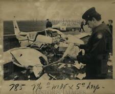 1971 Press Photo Airplane Accident- Fireman studies pilot's map, Lakefront crash picture