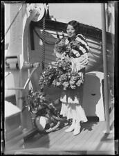 Miss Carrie Young Wai standing on the deck of a ship with flow - 1930s Old Photo picture