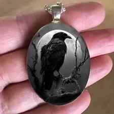 Raven Moon necklace under convex glass on an approx. 18