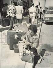 1973 Press Photo Mrs. Helen Reckis waits for her husband after moving baggage picture