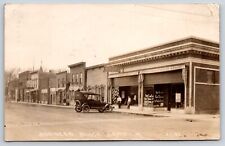 Britt Iowa~Business Block~Drug Store~Meat Market 14c lb~Harness Shop~1920 RPPC picture