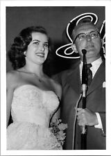 Pretty woman in wedding dress next to man w/microphone Found Photo V0509 picture