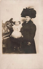 VINTAGE RPPC POSTCARD LADY IN ENORMOUS HAT WITH CHILD IN FUR & FEATHERS 82423 S picture