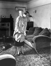 Housewife using a vacuum cleaner in the living room 1930s Old Photo picture