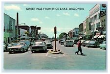 c1960s Cars and Pedestrian Greetings from Rice Lake Wisconsin WI Postcard picture