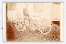 RPPC EARLY 1900'S. MAN IN OVERALLS ON EARLY MOTORCYCLE. POSTCARD. GG18 picture