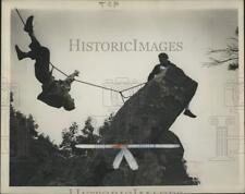 1945 Press Photo Mountain climbers cross a rope over a chasm during a climb. picture