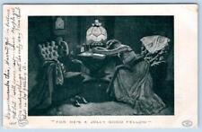 1909 FOR HE'S A JOLLY GOOD FELLOW WOMAN LAYS ON BOOK TABLE FRINGED LAMP POSTCARD picture