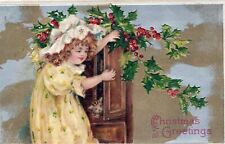 CHRISTMAS - Girl And Cat In Cupboard Christmas Greetings Postcard picture