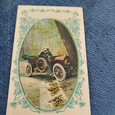 Vintage postcard of couple in car. the card has been mailed, postmarked 12/14/11 picture