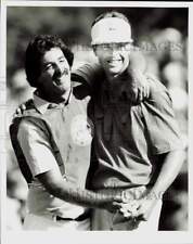 1986 Press Photo Golfer Bob Tway hugs caddy on during PGA tournament - afa75464 picture