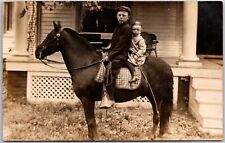 Two Young Boys on Black Horse Riding Front of Home RPPC Real Photo Postcard picture