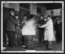 Outdoor workers,wholesale produce district,standing around bonfire,1950,New York picture